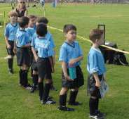 Standing in line waiting for their picture to be taken.